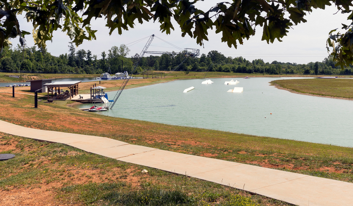 A cable pulls wake boarders through a “floating skate park” course at Elevated Wake Park.