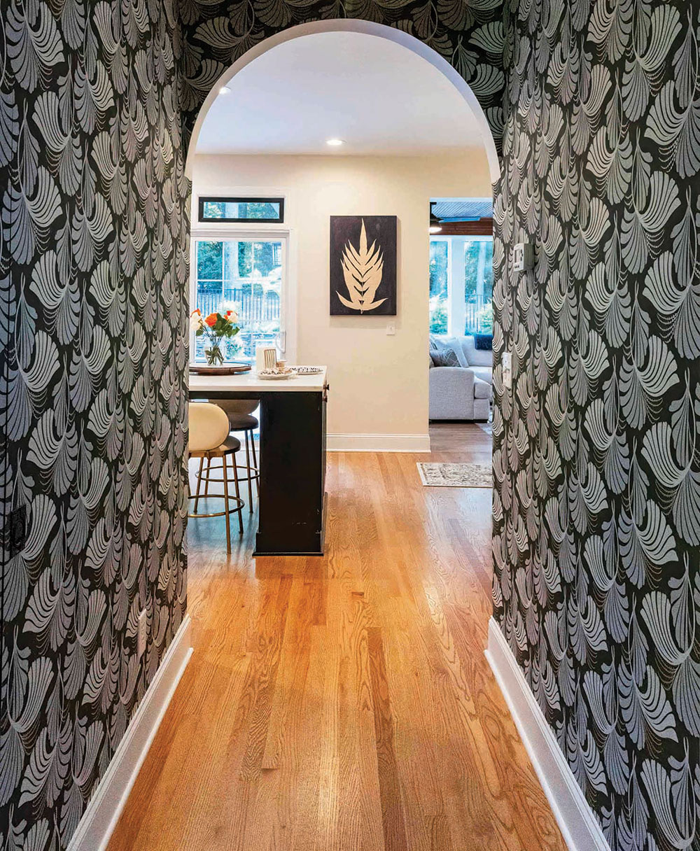 Bold patterned wallpaper disguises doors to a hidden pantry.