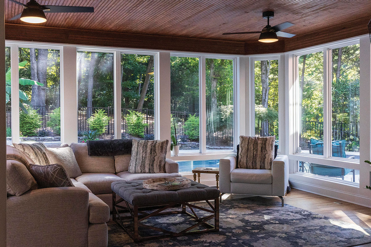 The bright sunroom is now open to the kitchen and offers beautiful views of the backyard pool.